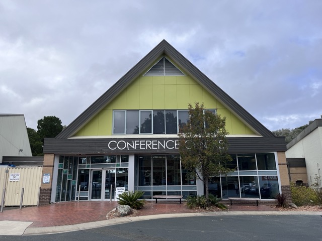 Photo: one of the conference buildings. It has signage: the word CONFERENCE. The N is wonky.